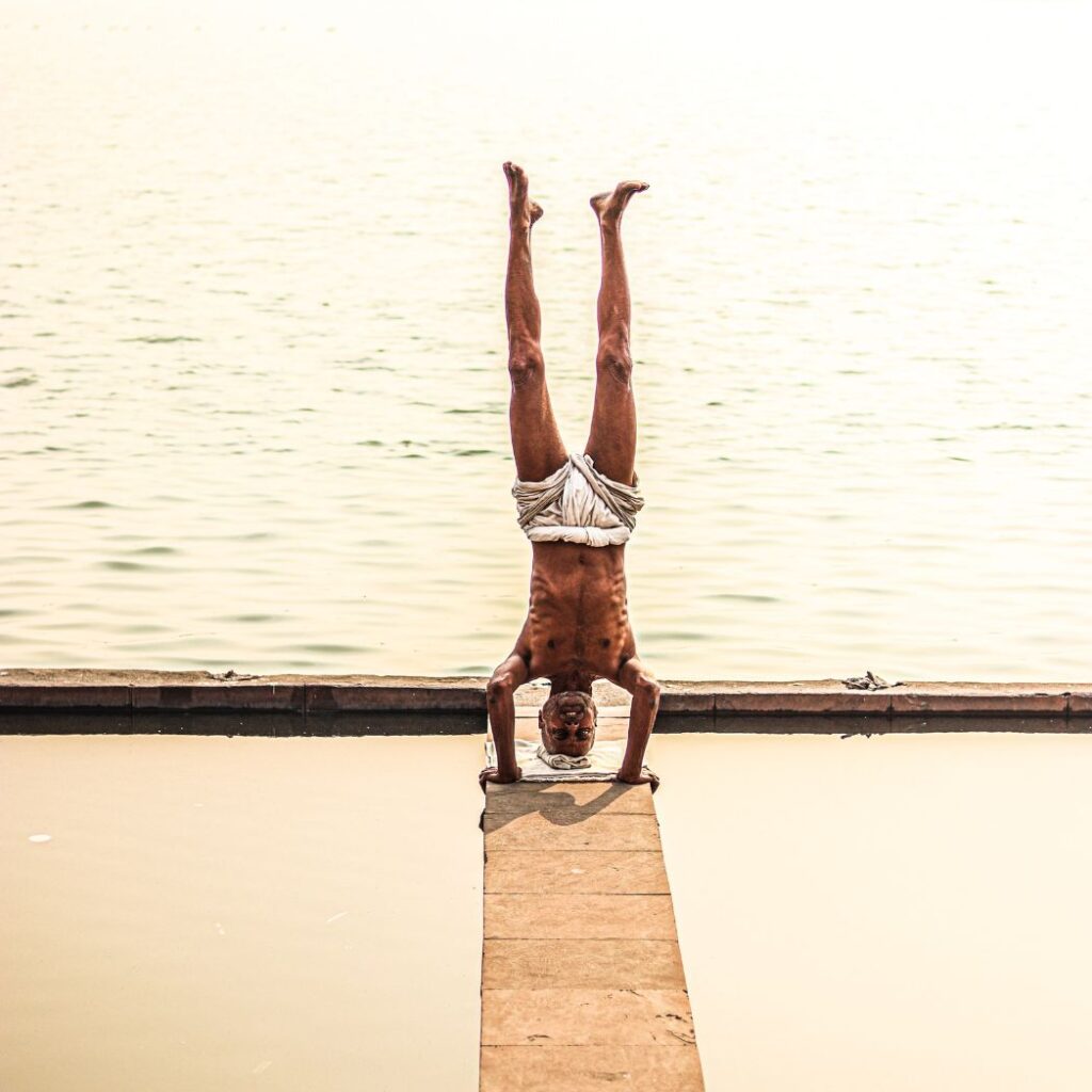 An individual performing a barbell squat, with a focus on their legs and back muscles. The exercise involves lifting a heavy weight while maintaining proper form, demonstrating the importance of compound exercises in building overall muscle mass and strength